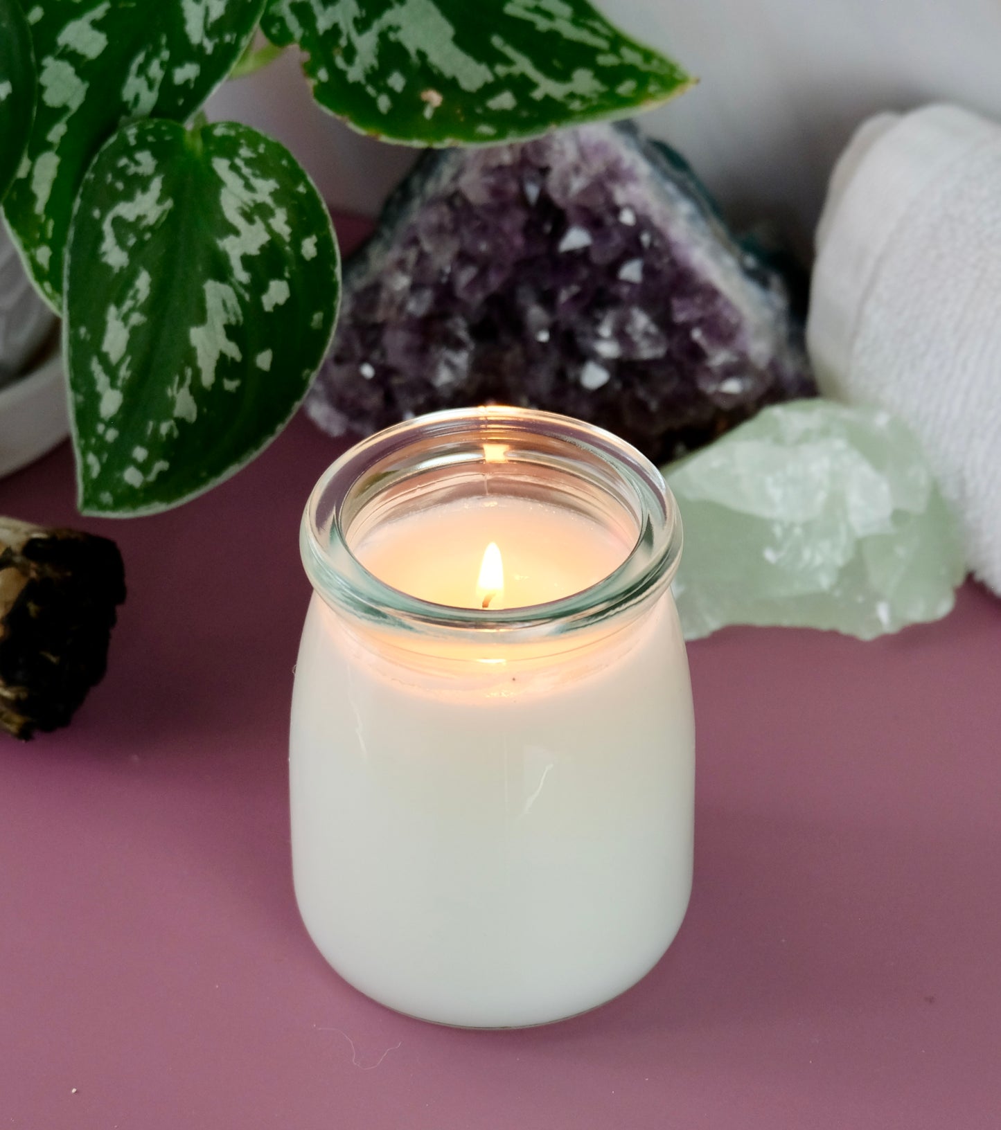 A lit body oil candle