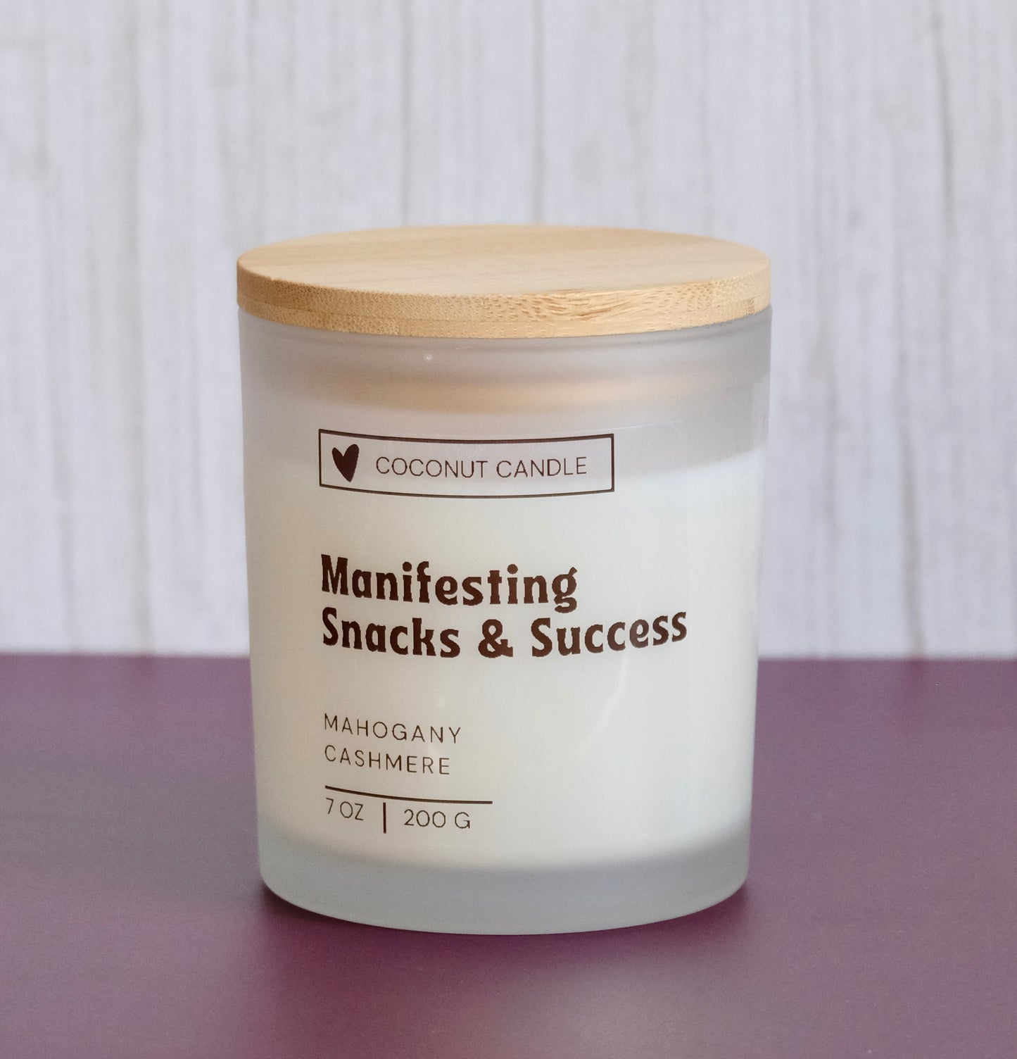 Customizable frosted glass candle with the words Manifesting Snacks & Success