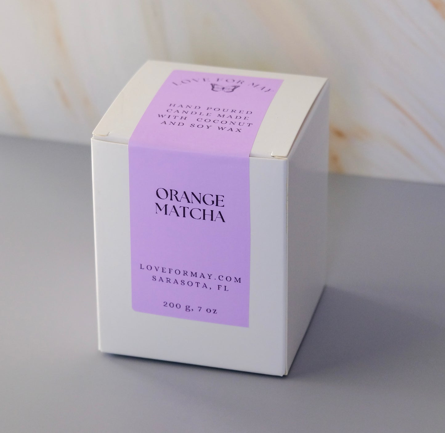 White candle box with a purple label