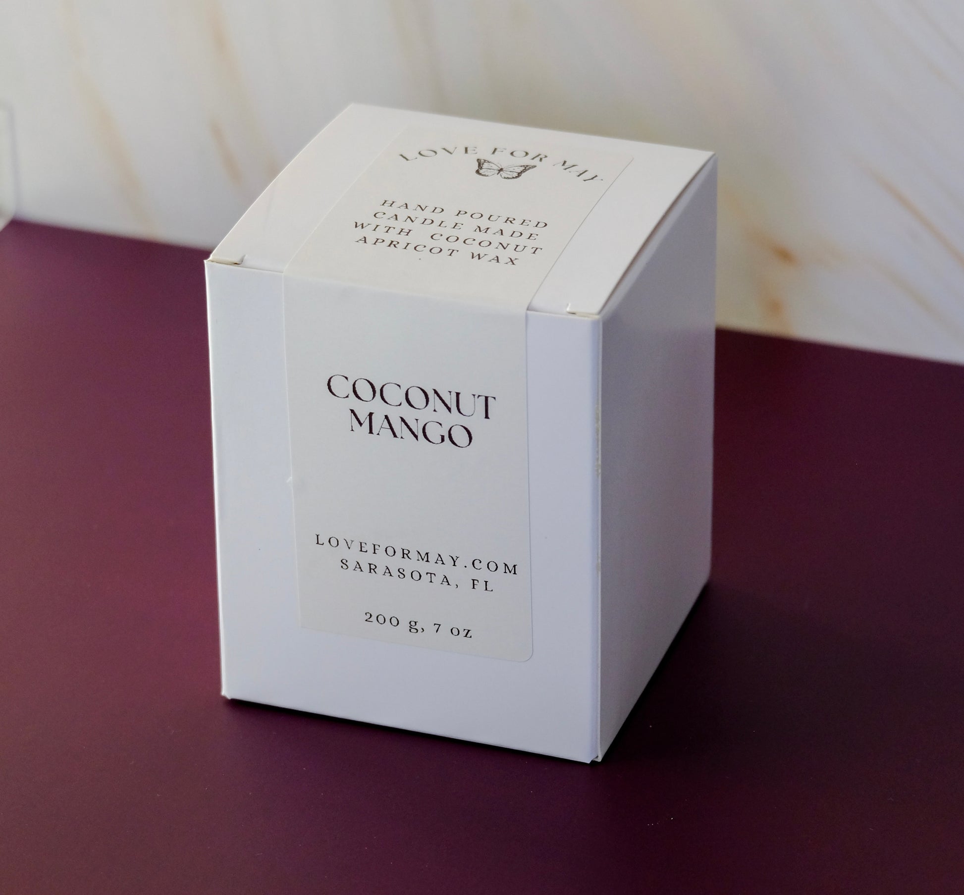 A white candle box with a white label