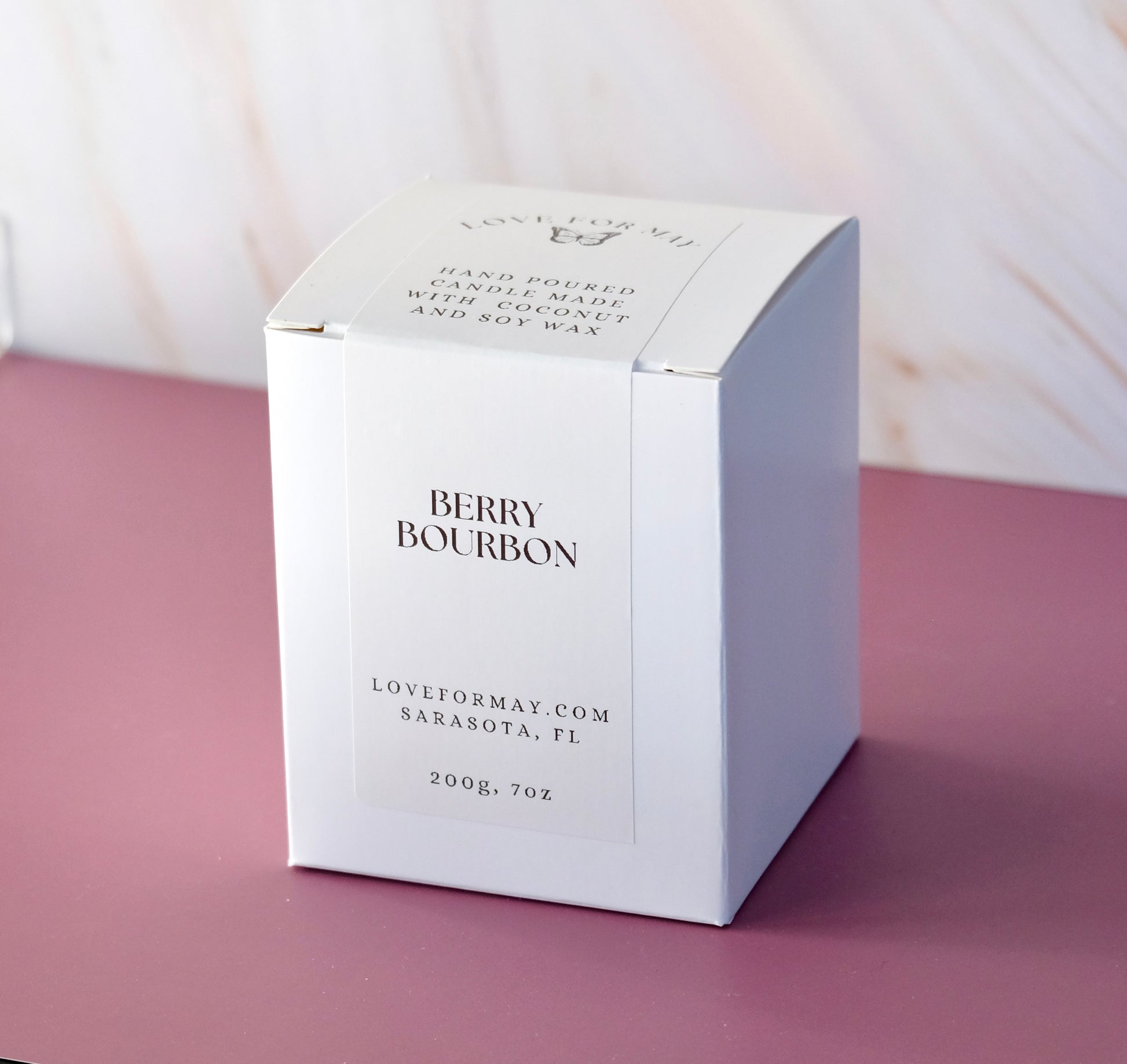 White candle box for a candle with the scent berry bourbon.