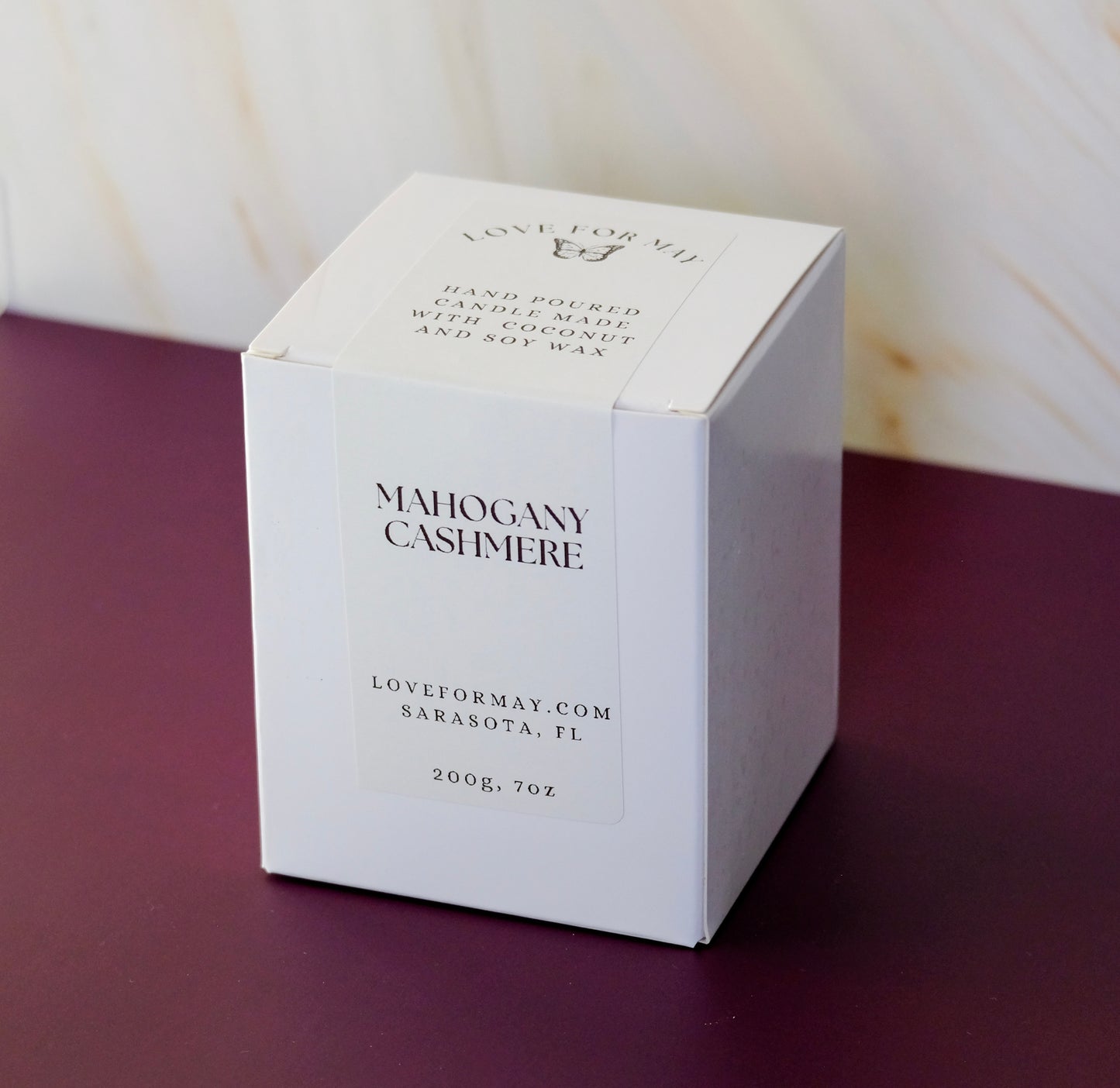 A white candle box with a white label