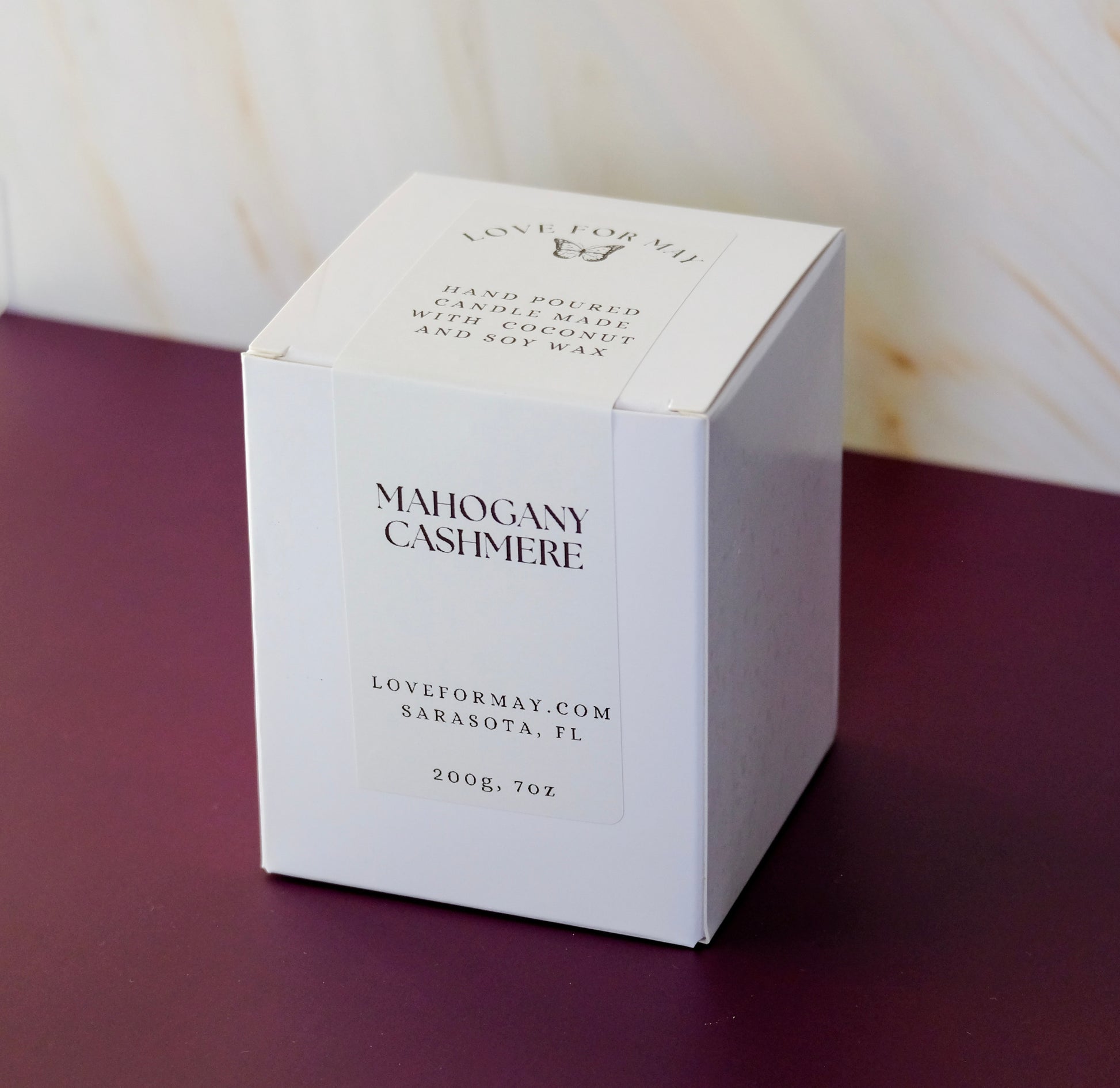 A white candle box with a white label