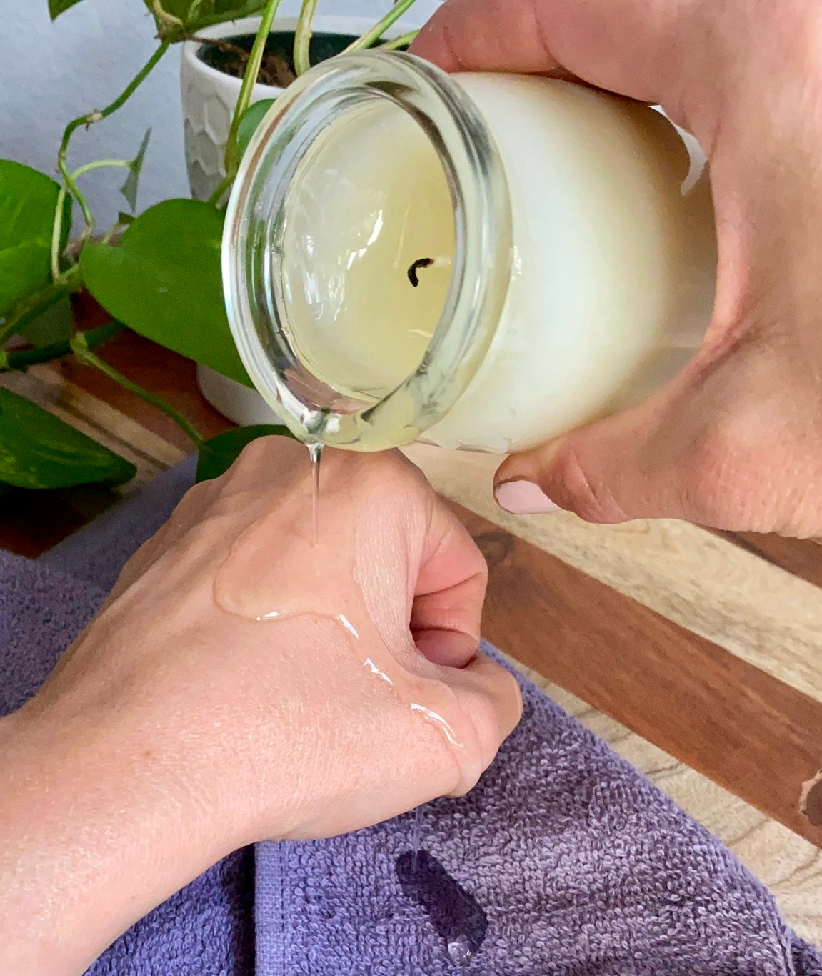 Pouring oil from a massage candle onto hand