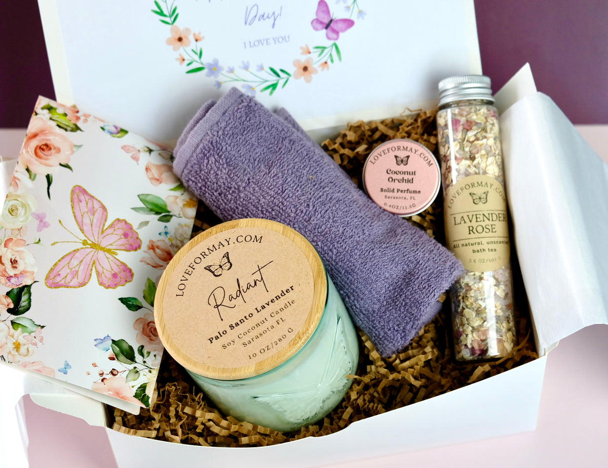 Gift set with candle, towel, solid perfume and lavender bath tea in a decorative butterfly-themed box.