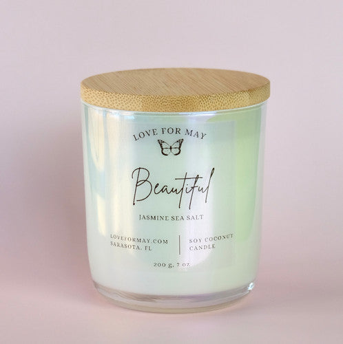 Jasmine Sea Salt scented candle in a frosted glass jar with a bamboo lid and the word beautiful on the label.