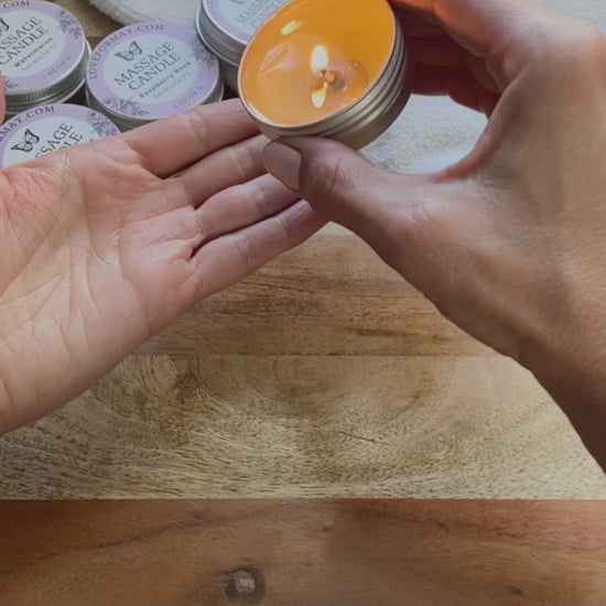 Hands pouring and scooping out oil from a massage candle onto skin and massaging the skin.