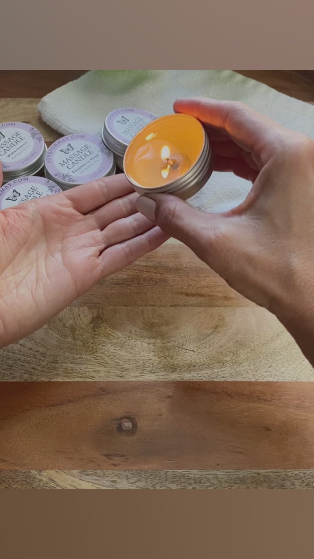 Hands pouring and scooping out oil from a massage candle onto skin and massaging the skin.